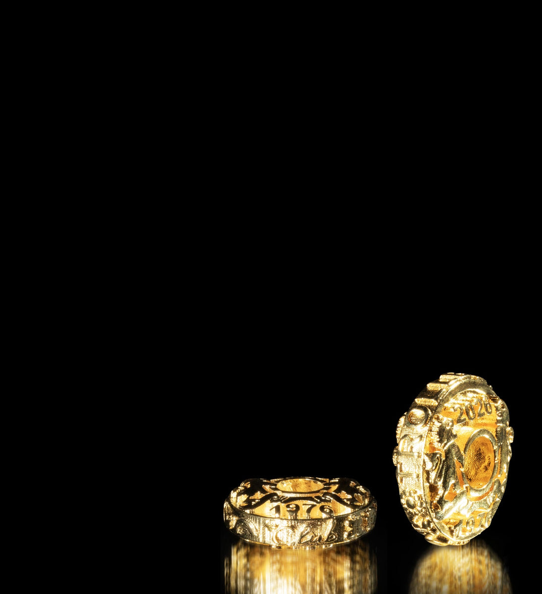 Gold plated coins with many details on black background